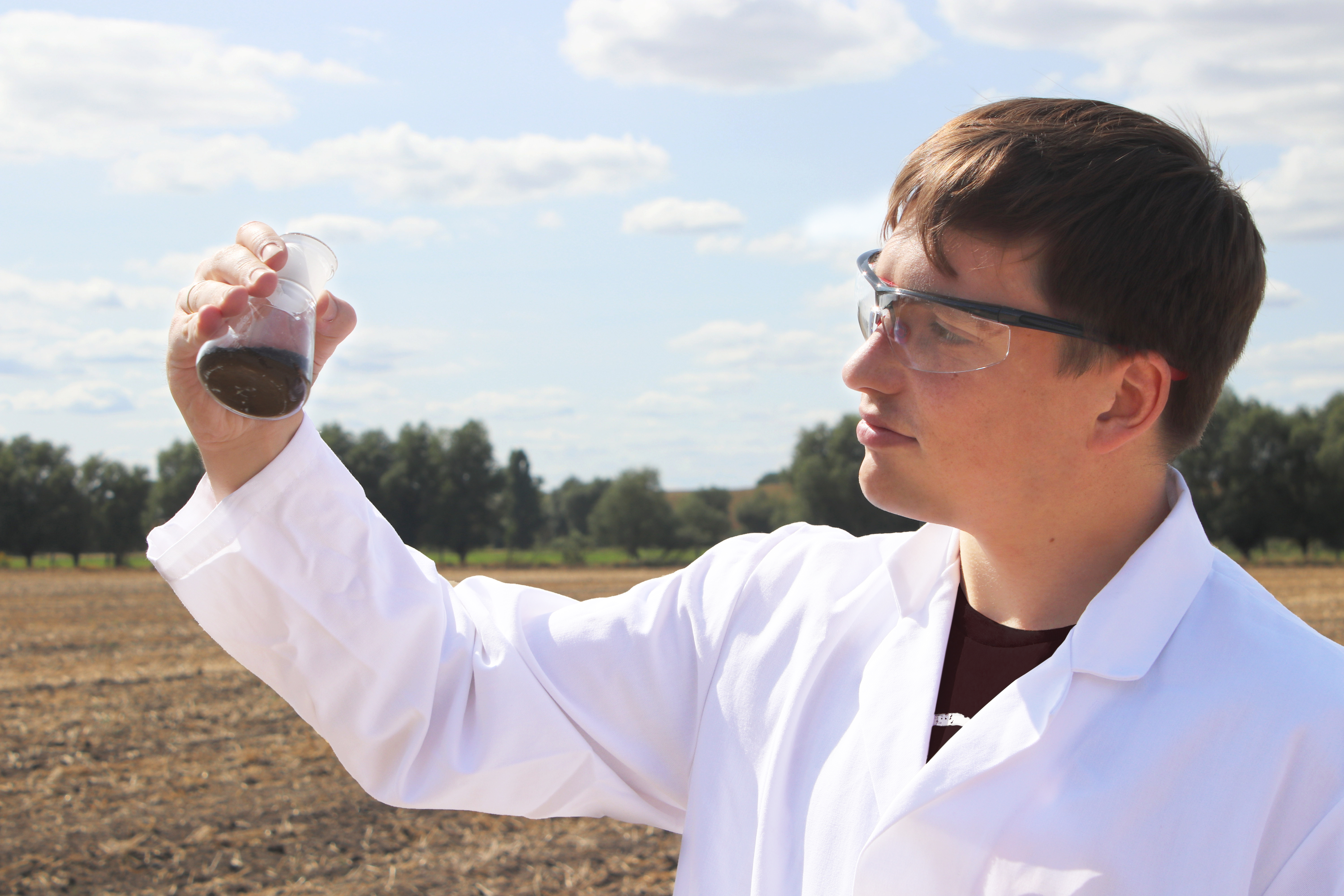 A scientist takes a soil sample for further investigation.